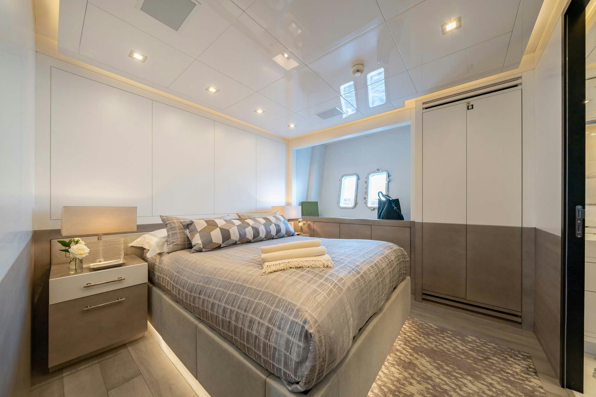 a bedroom with a bed and a desk aboard DA VINCI Yacht for Charter