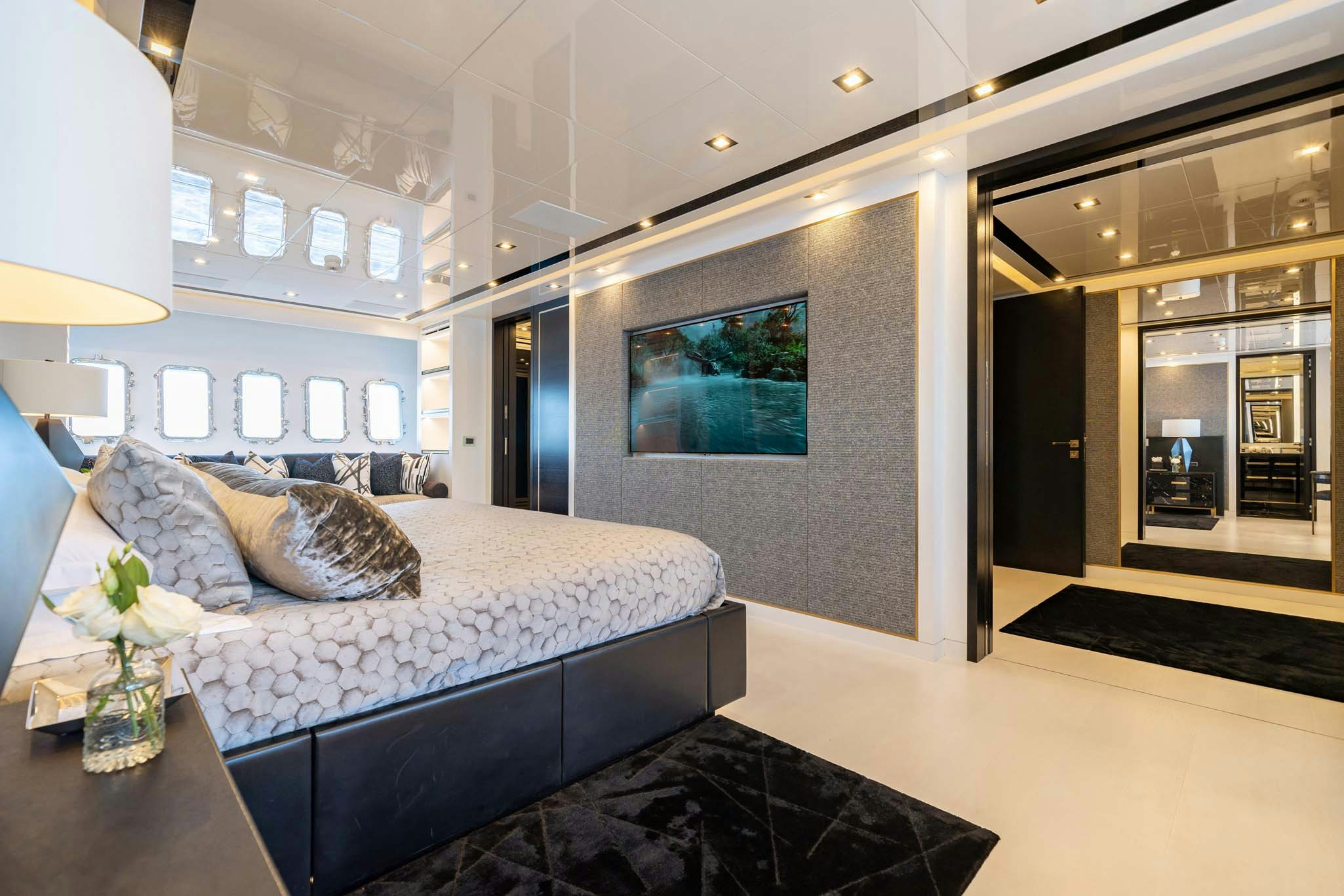 a room with a bed and a table aboard DA VINCI Yacht for Charter