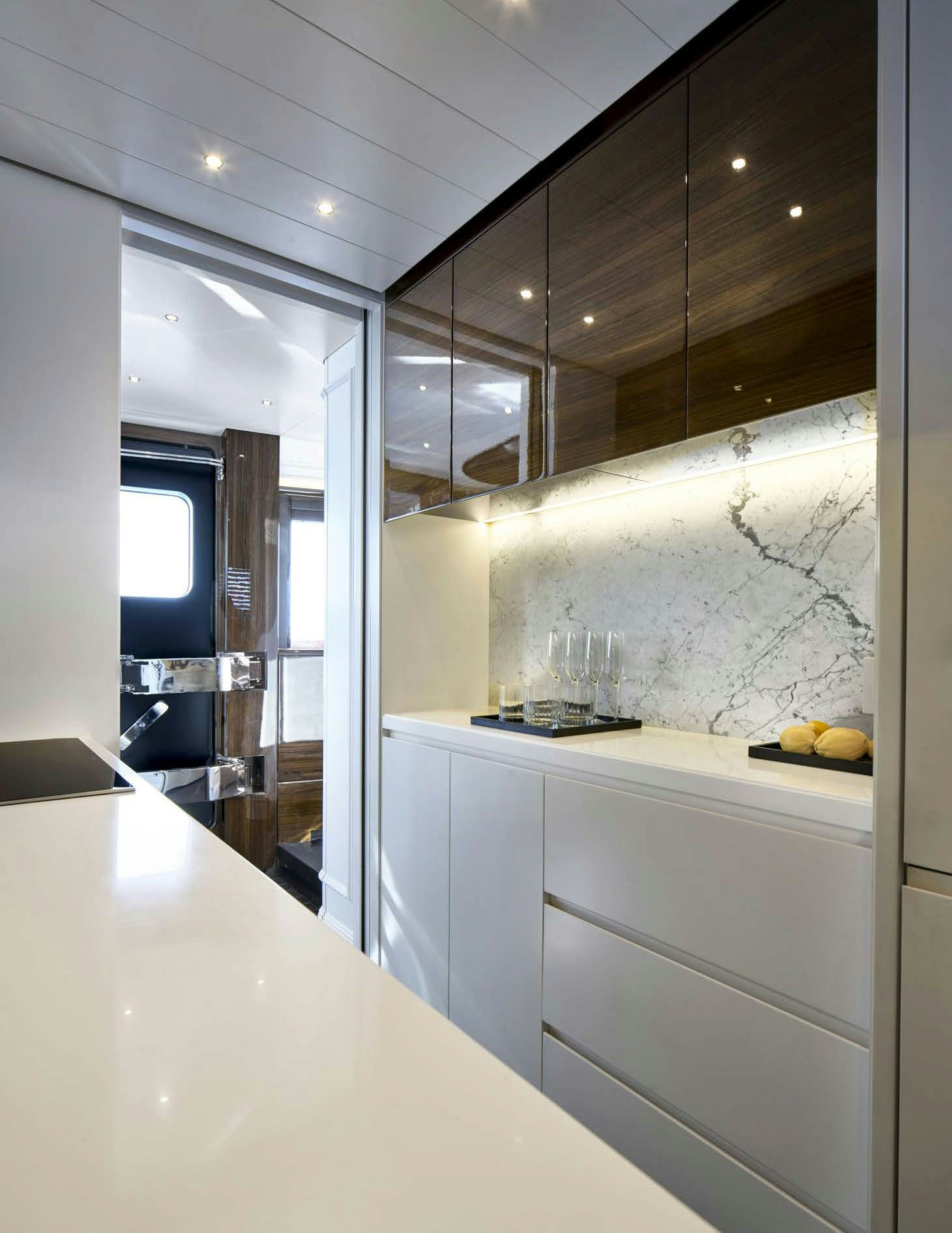 a kitchen with white cabinets aboard PICCHIOTTI GENTLEMAN 24M Yacht for Sale