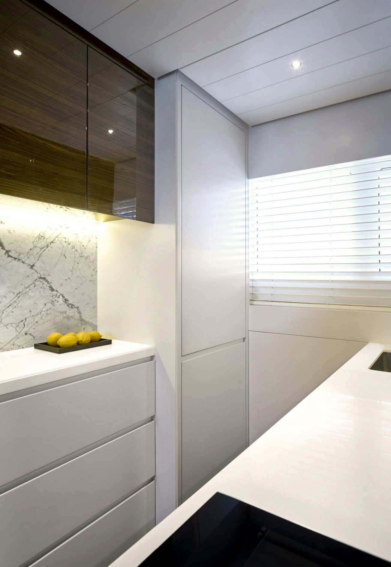 a white kitchen with a white counter aboard PICCHIOTTI GENTLEMAN 24M Yacht for Sale