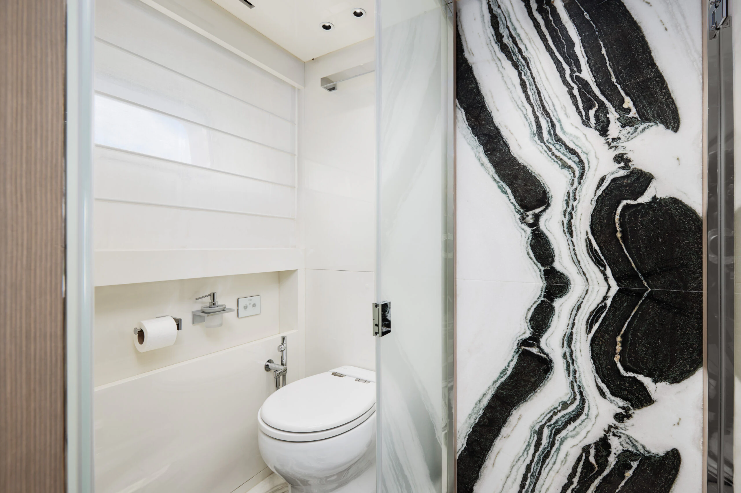 a bathroom with a black and white shower curtain aboard ZAFFIRO III Yacht for Sale