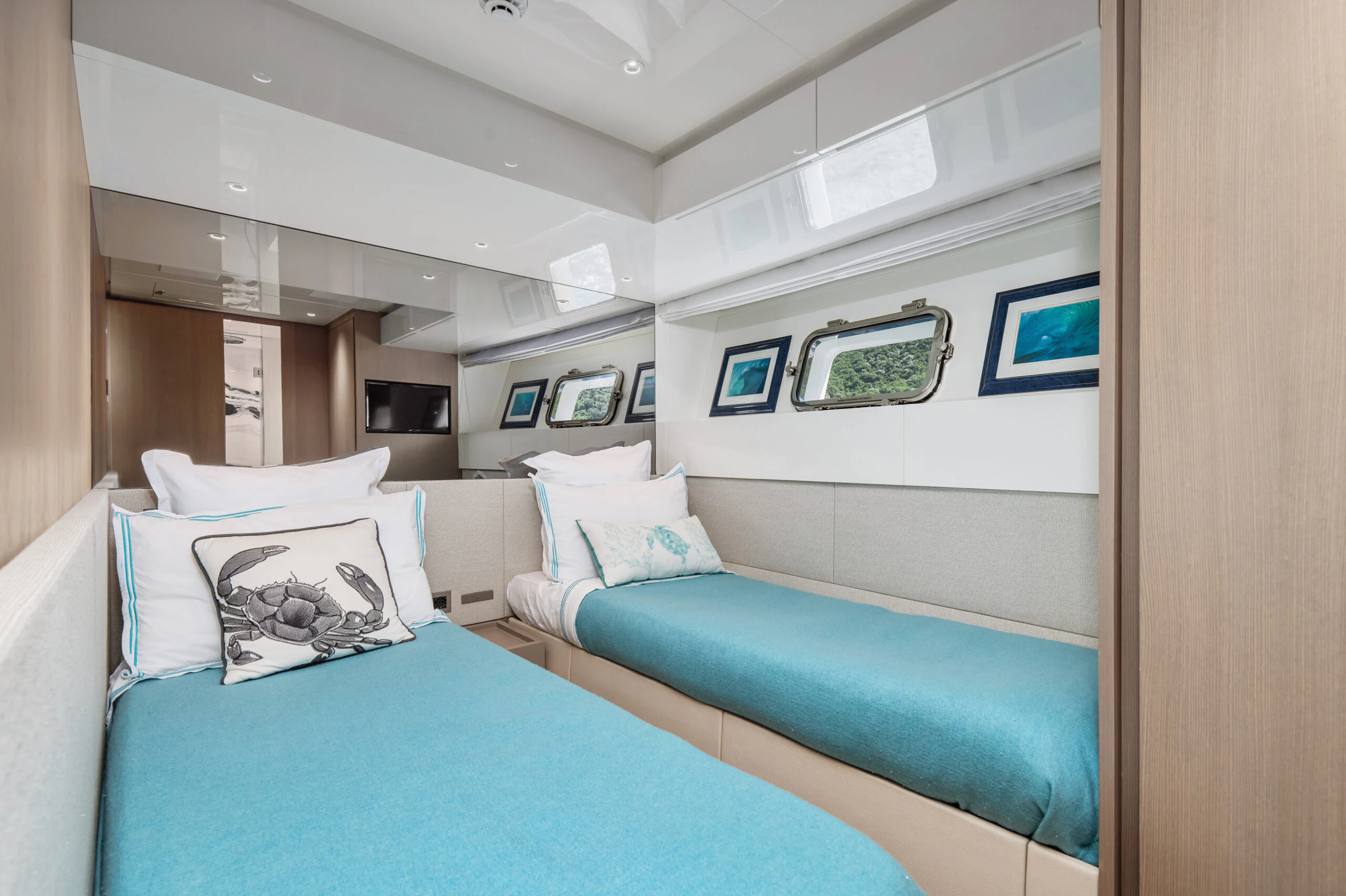 a room with a blue bed and white pillows aboard ZAFFIRO III Yacht for Sale