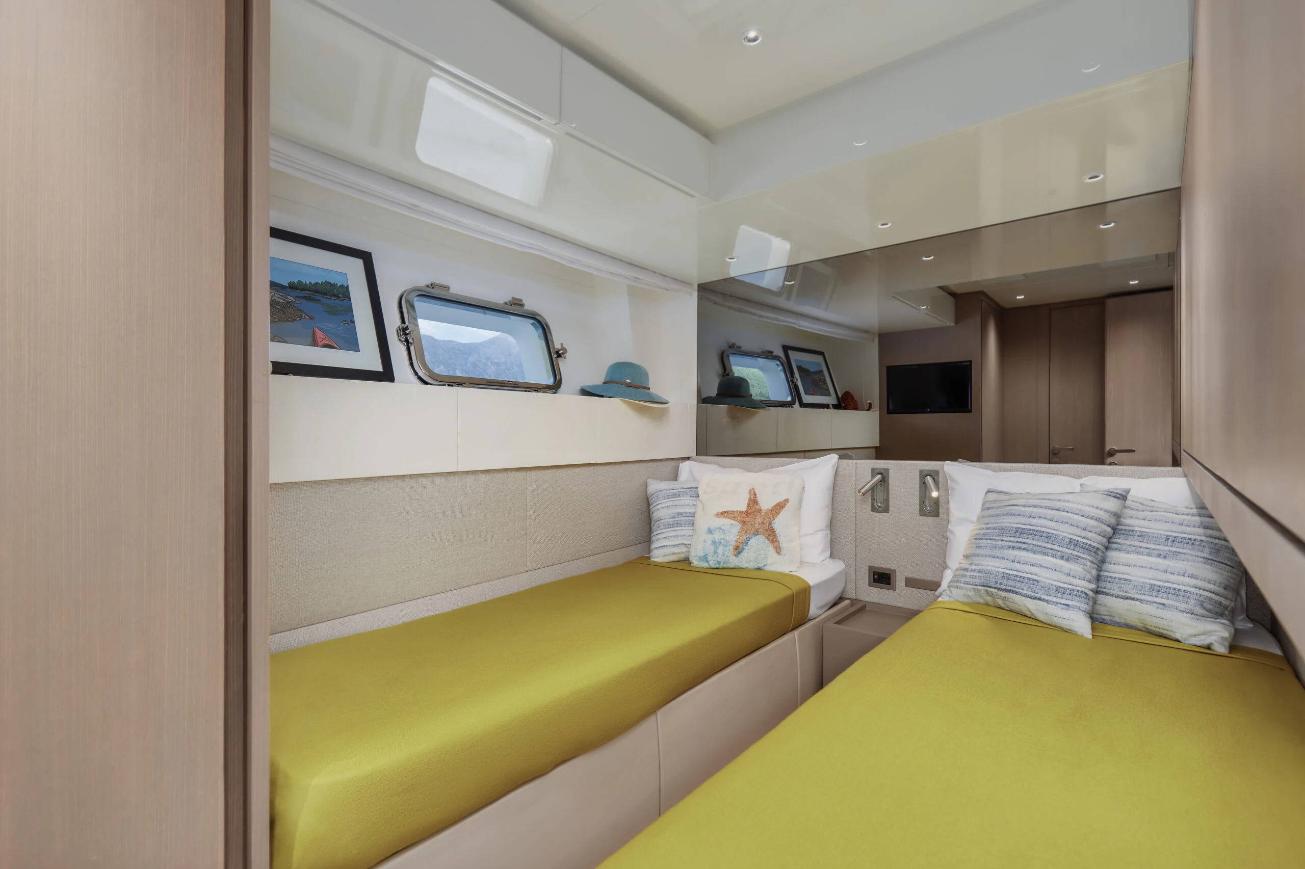 a room with a bed and a tv on the wall aboard ZAFFIRO III Yacht for Sale