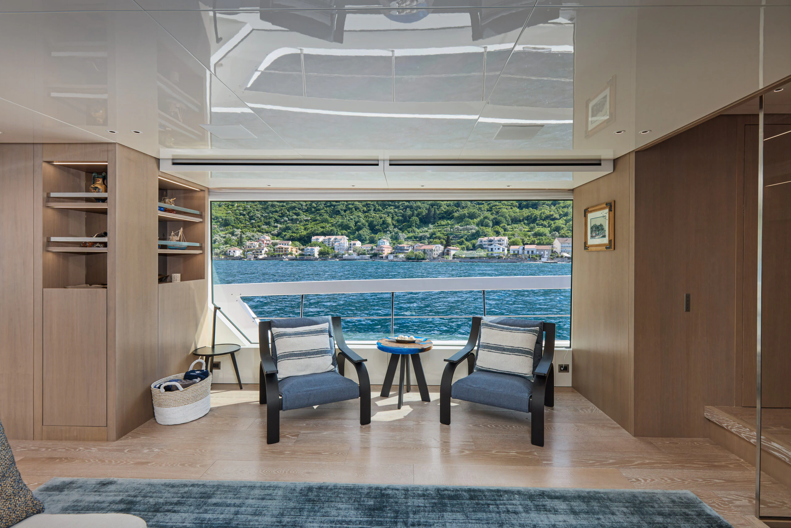 a room with a table chairs and a window aboard ZAFFIRO III Yacht for Sale