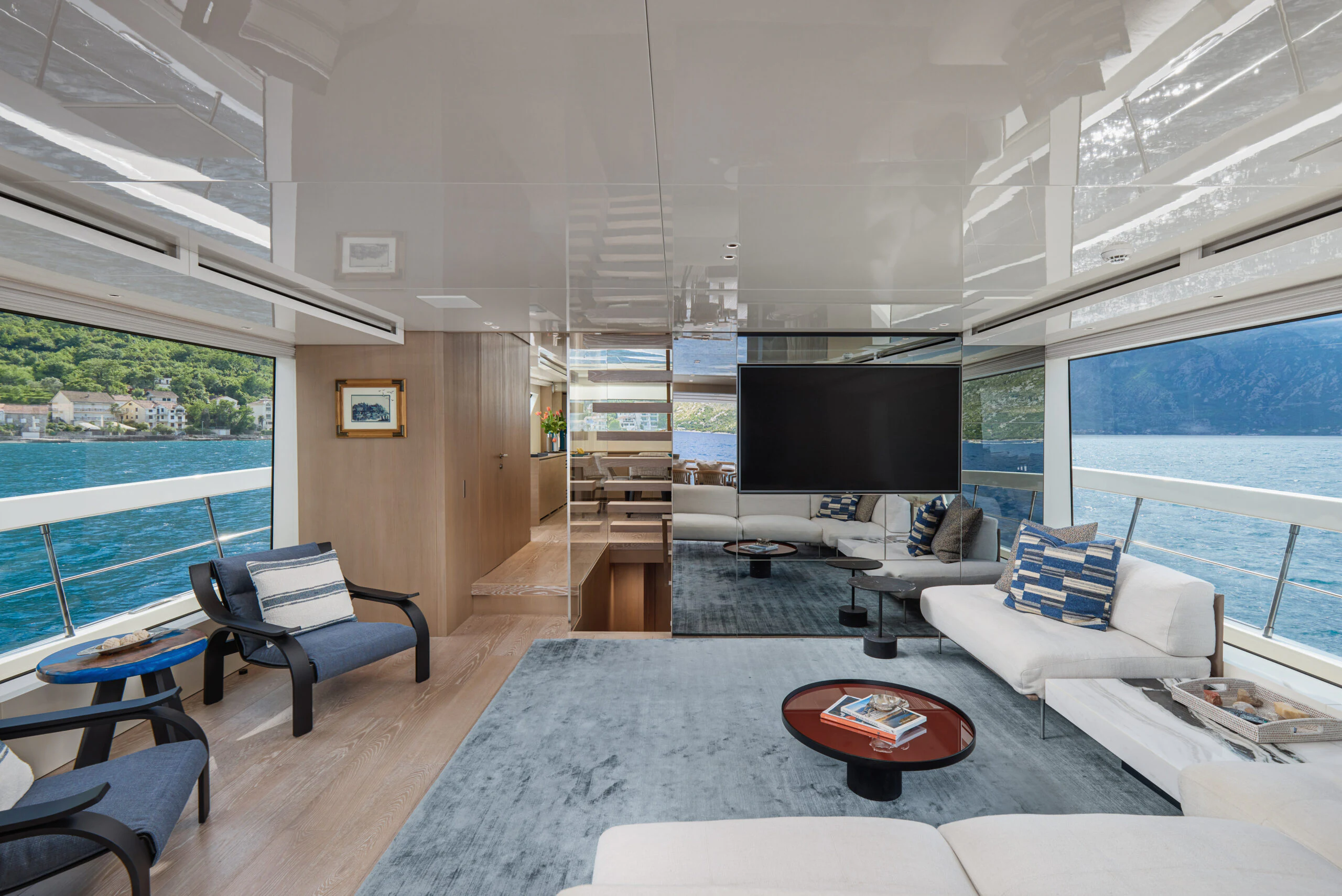 a living room with a large window aboard ZAFFIRO III Yacht for Sale