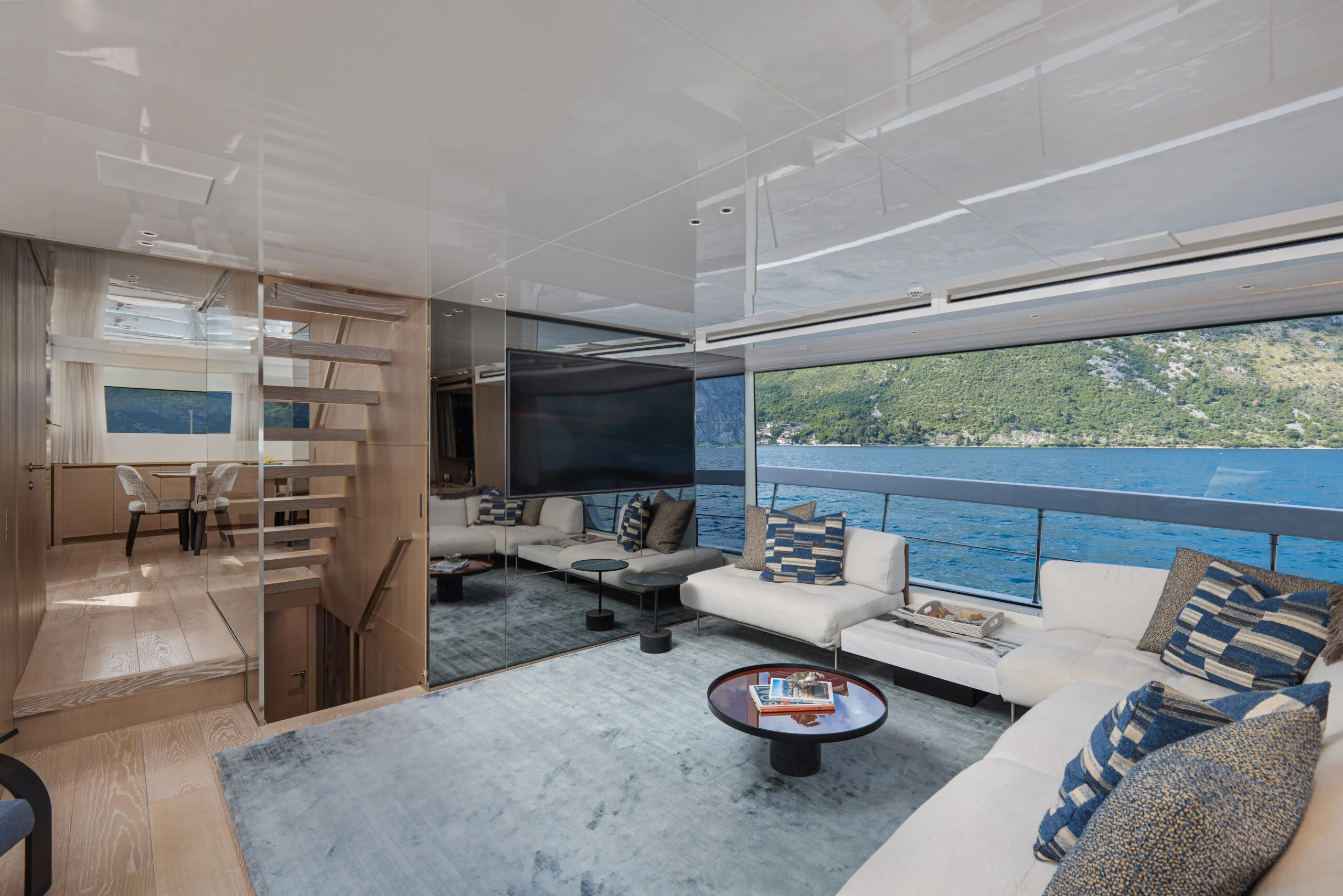 a living room with a large window aboard ZAFFIRO III Yacht for Sale