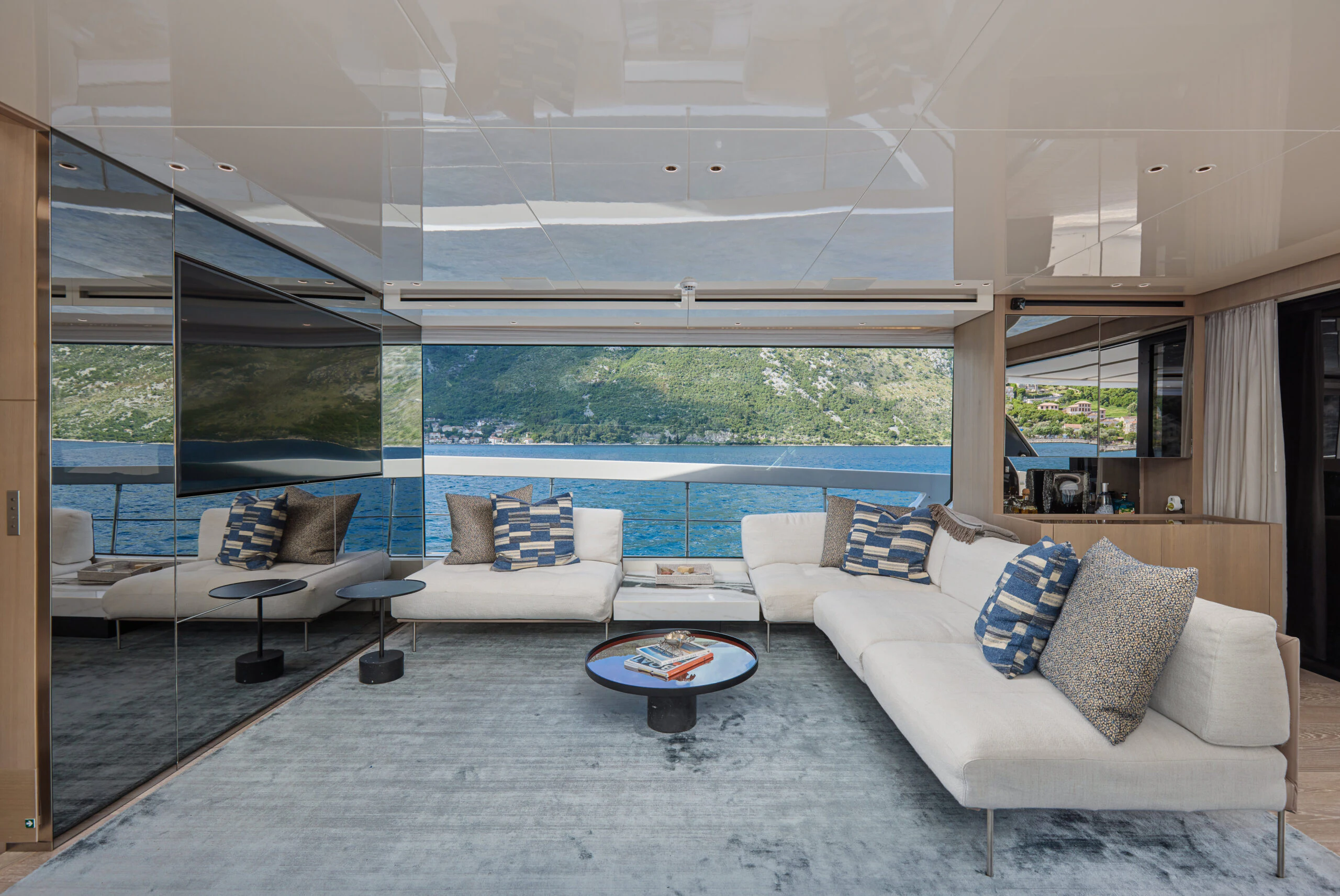 a living room with a large window aboard ZAFFIRO III Yacht for Sale