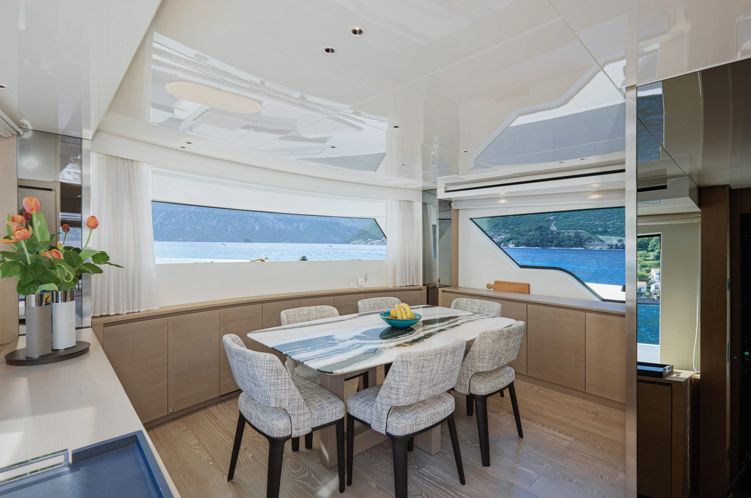 a room with a table and chairs aboard ZAFFIRO III Yacht for Sale