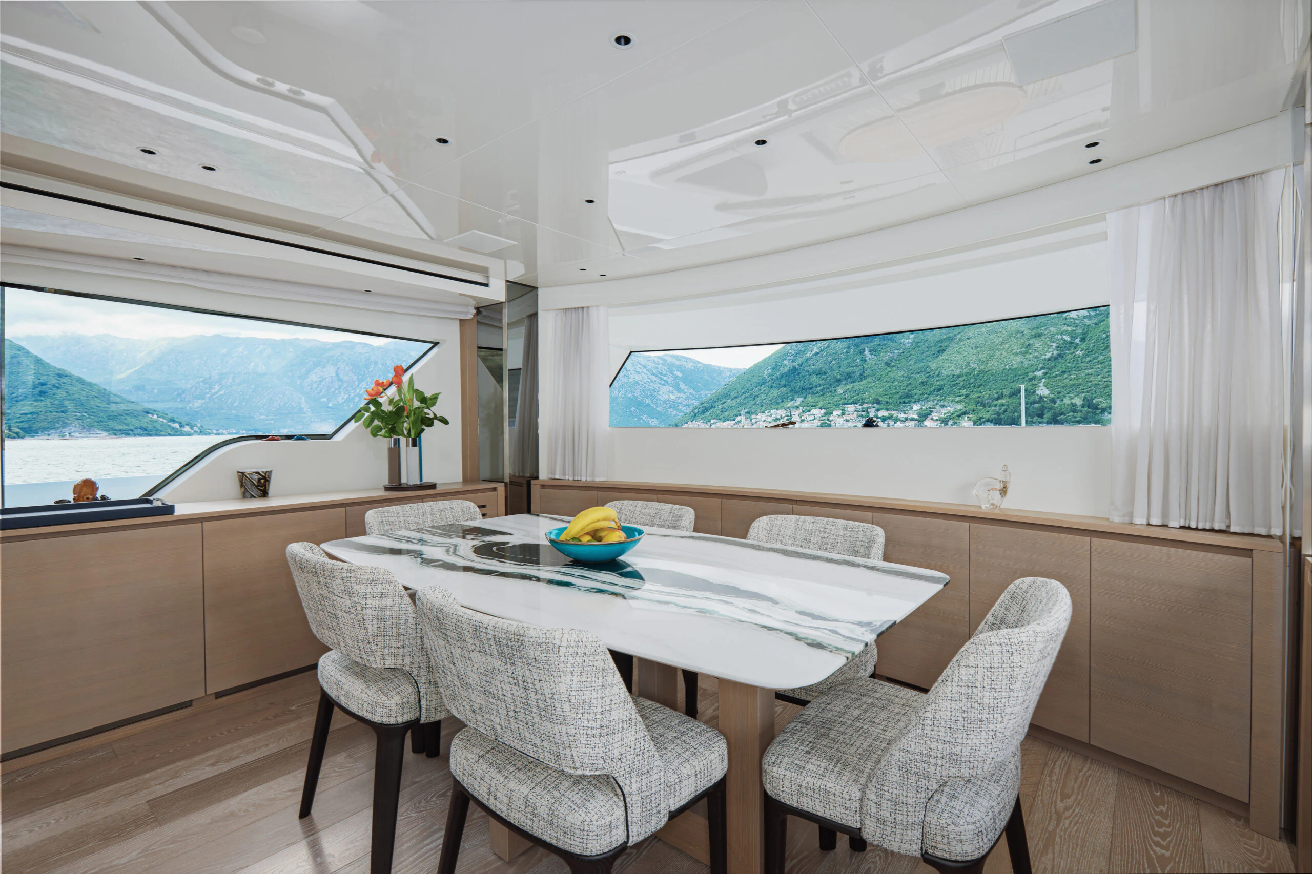 a room with a table and chairs aboard ZAFFIRO III Yacht for Sale
