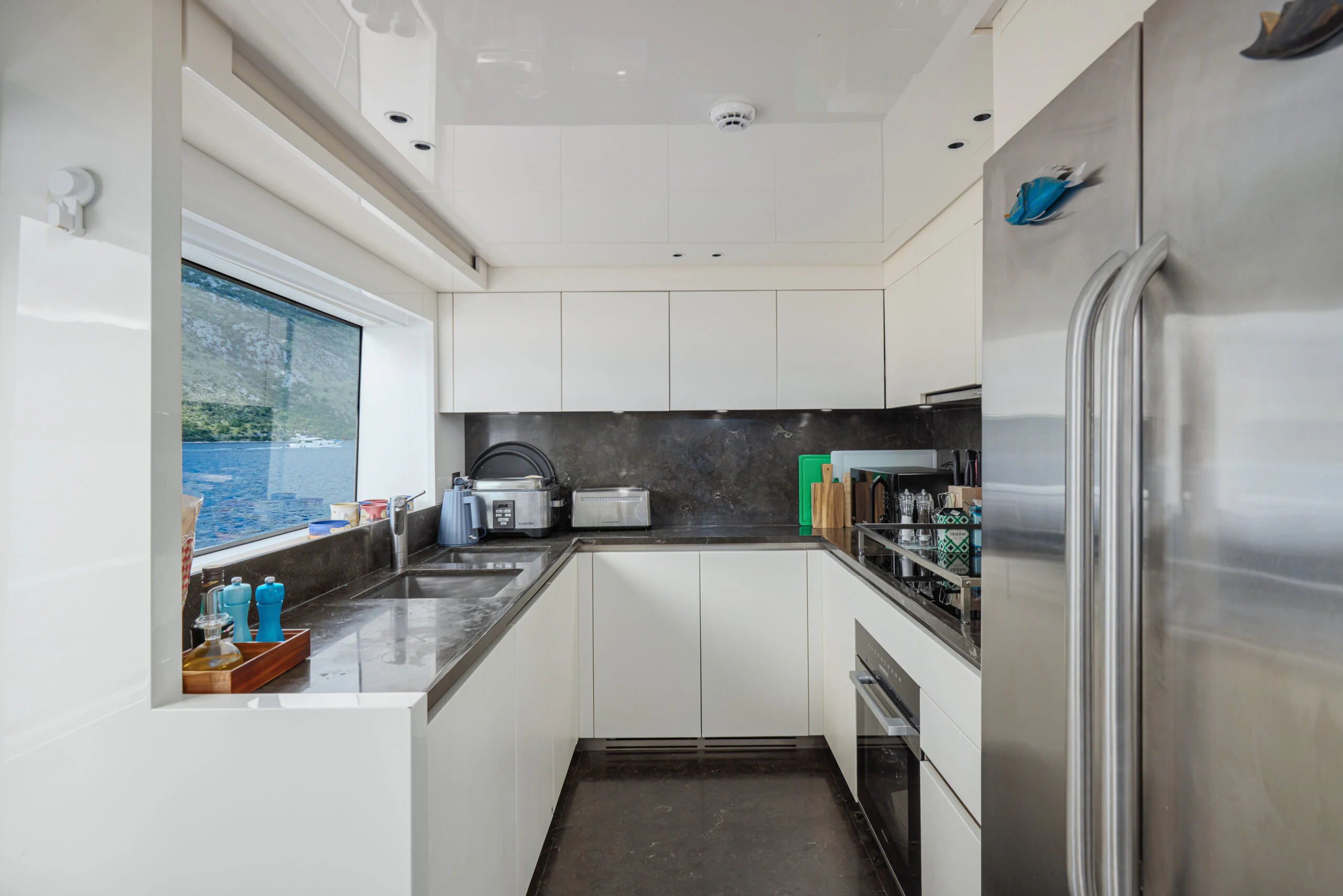 a kitchen with stainless steel appliances aboard ZAFFIRO III Yacht for Sale