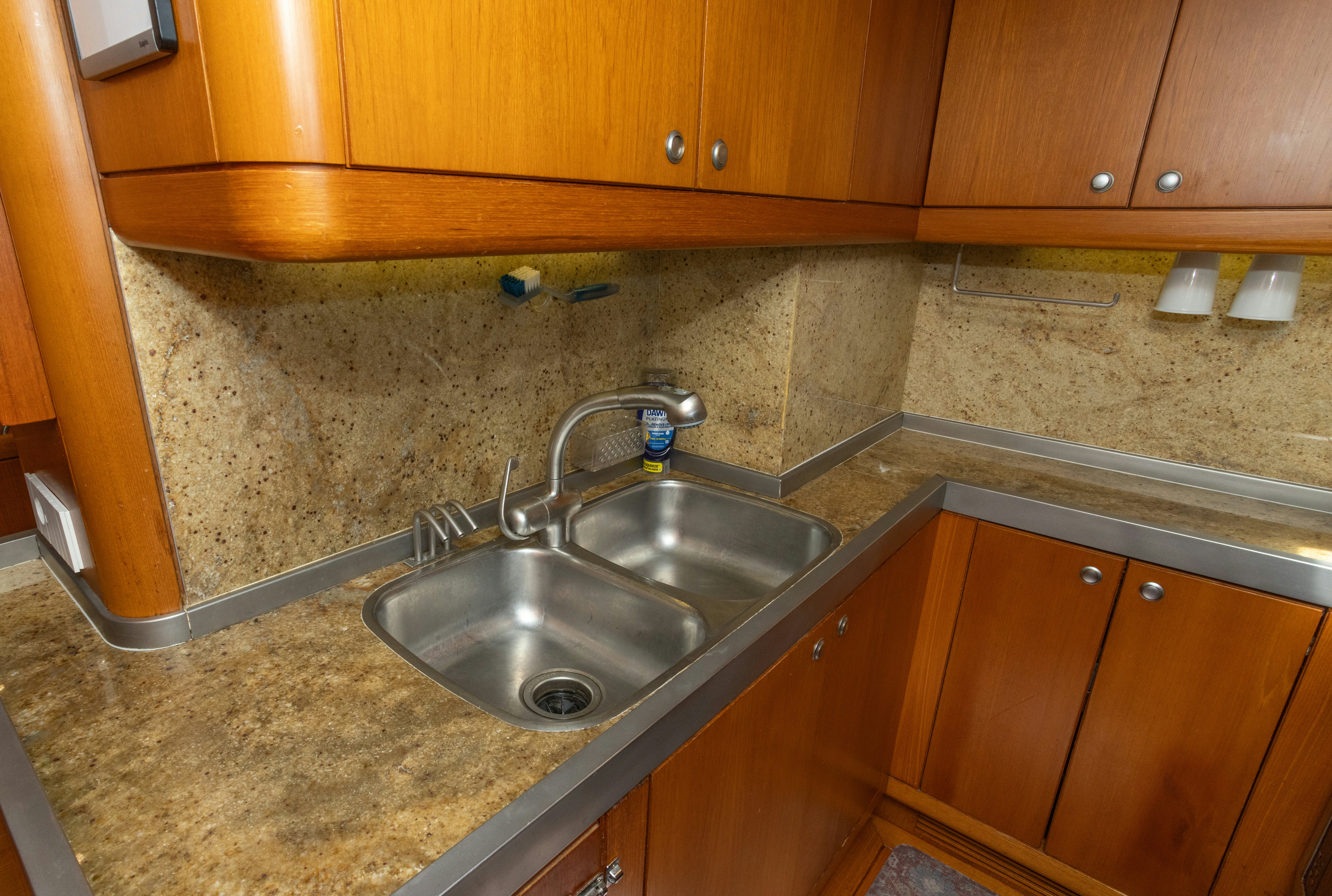 a kitchen with a sink and wooden cabinets aboard RED SKY Yacht for Sale