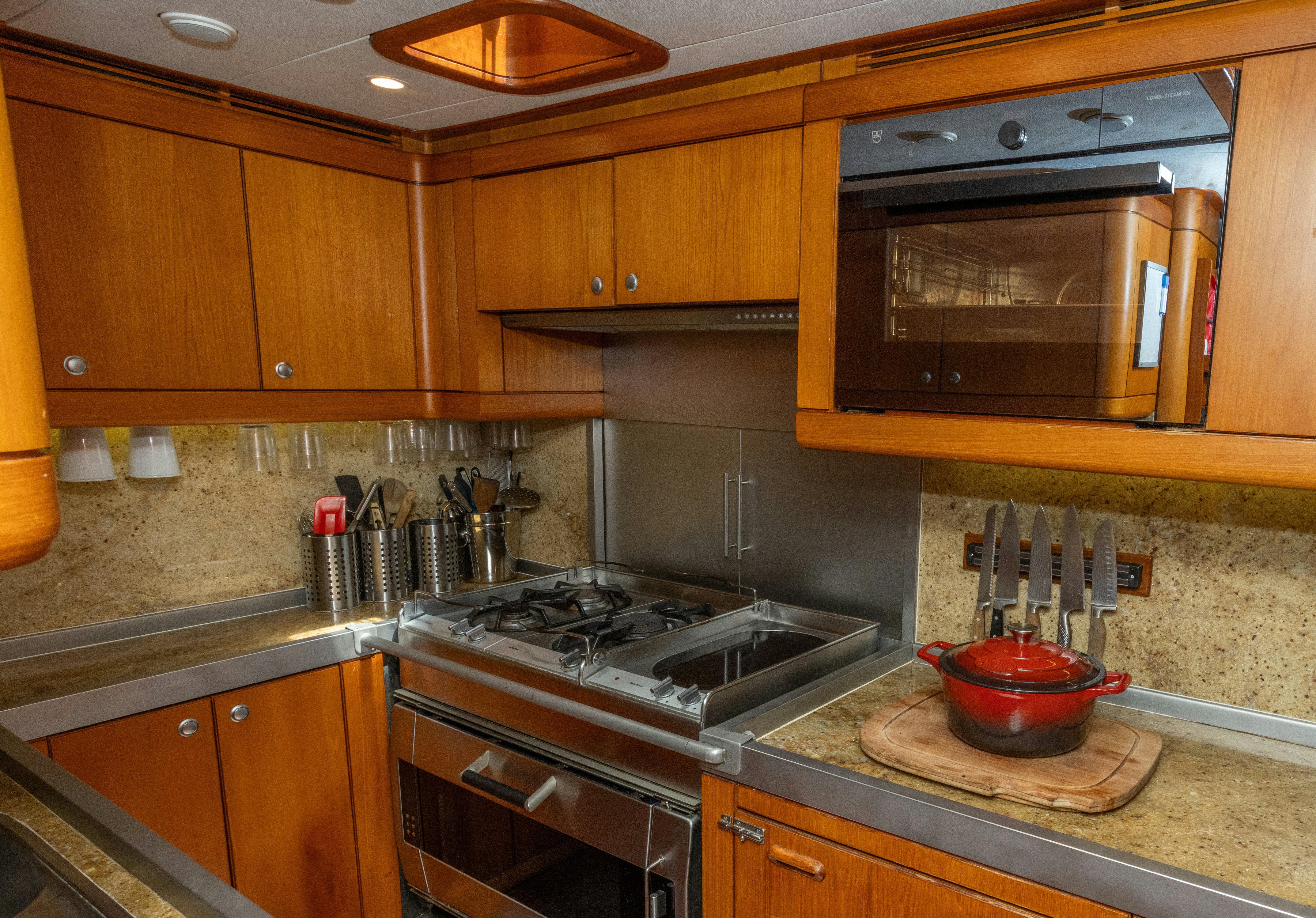 a kitchen with wooden cabinets aboard RED SKY Yacht for Sale