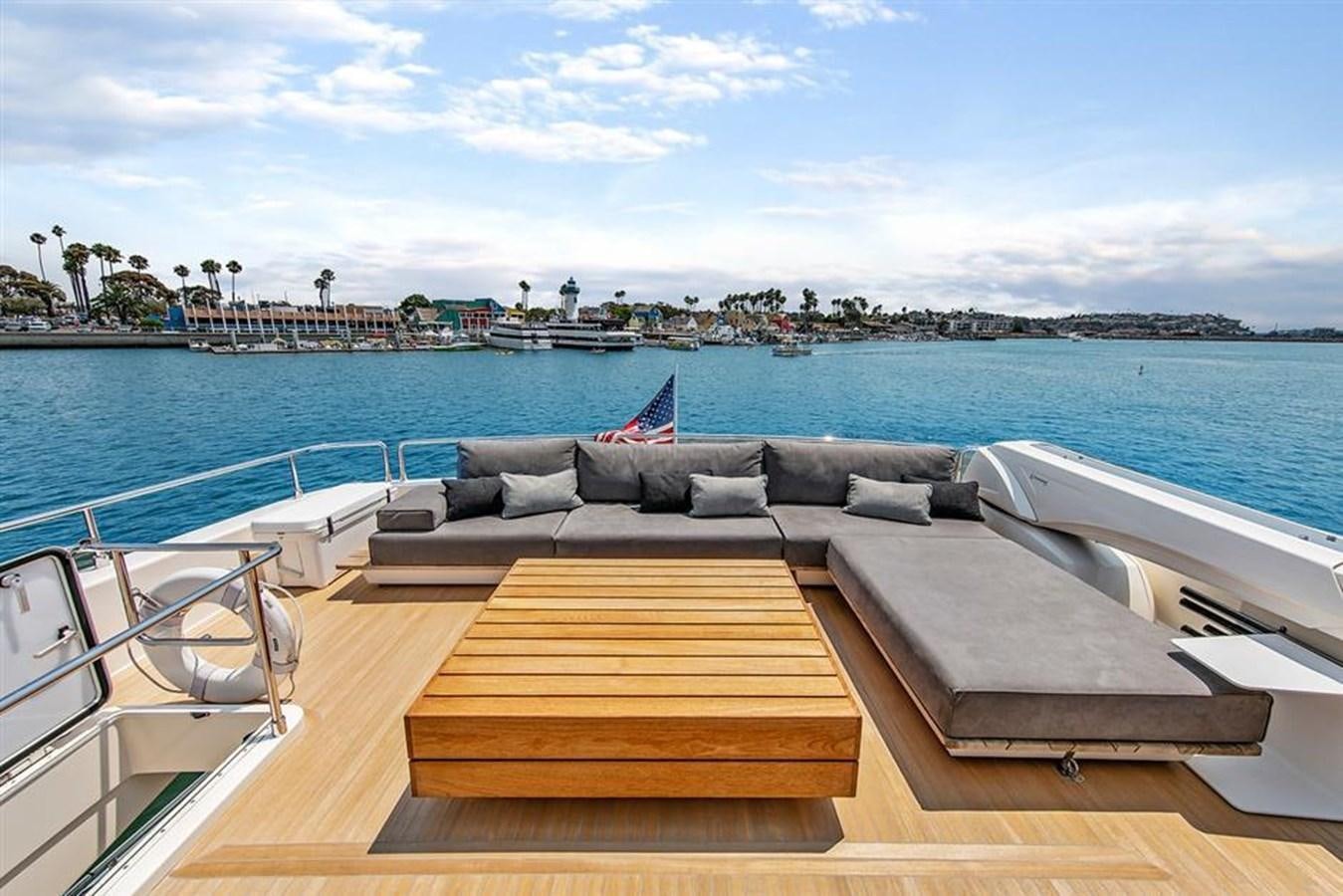 a deck with a couch and a pool of water aboard LONTANO Yacht for Sale