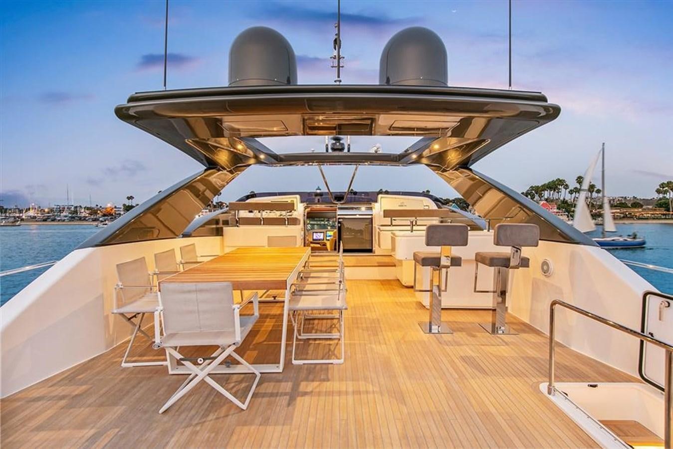 a deck with a large ship in the background aboard LONTANO Yacht for Sale