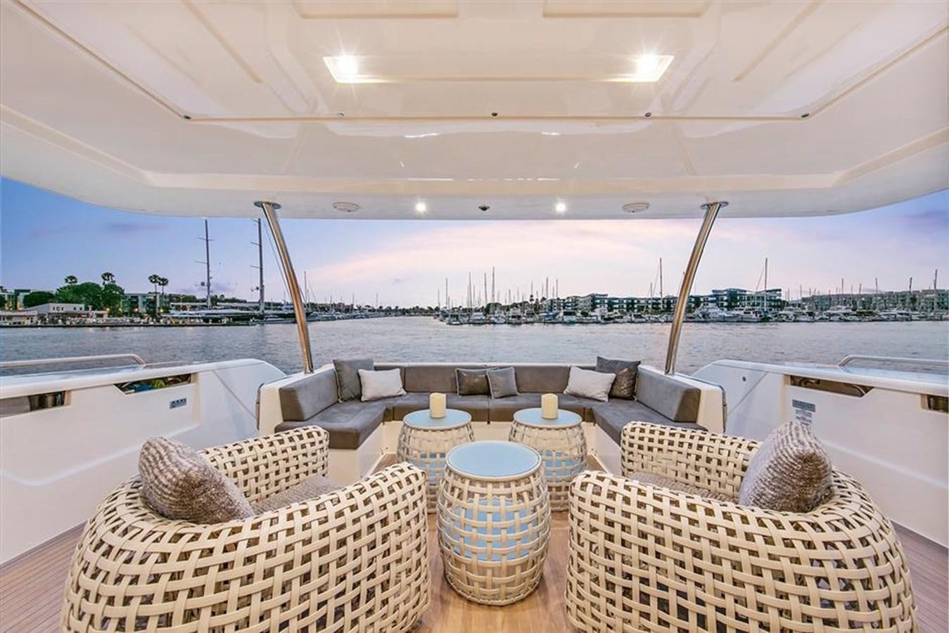 a patio with chairs and a table aboard LONTANO Yacht for Sale