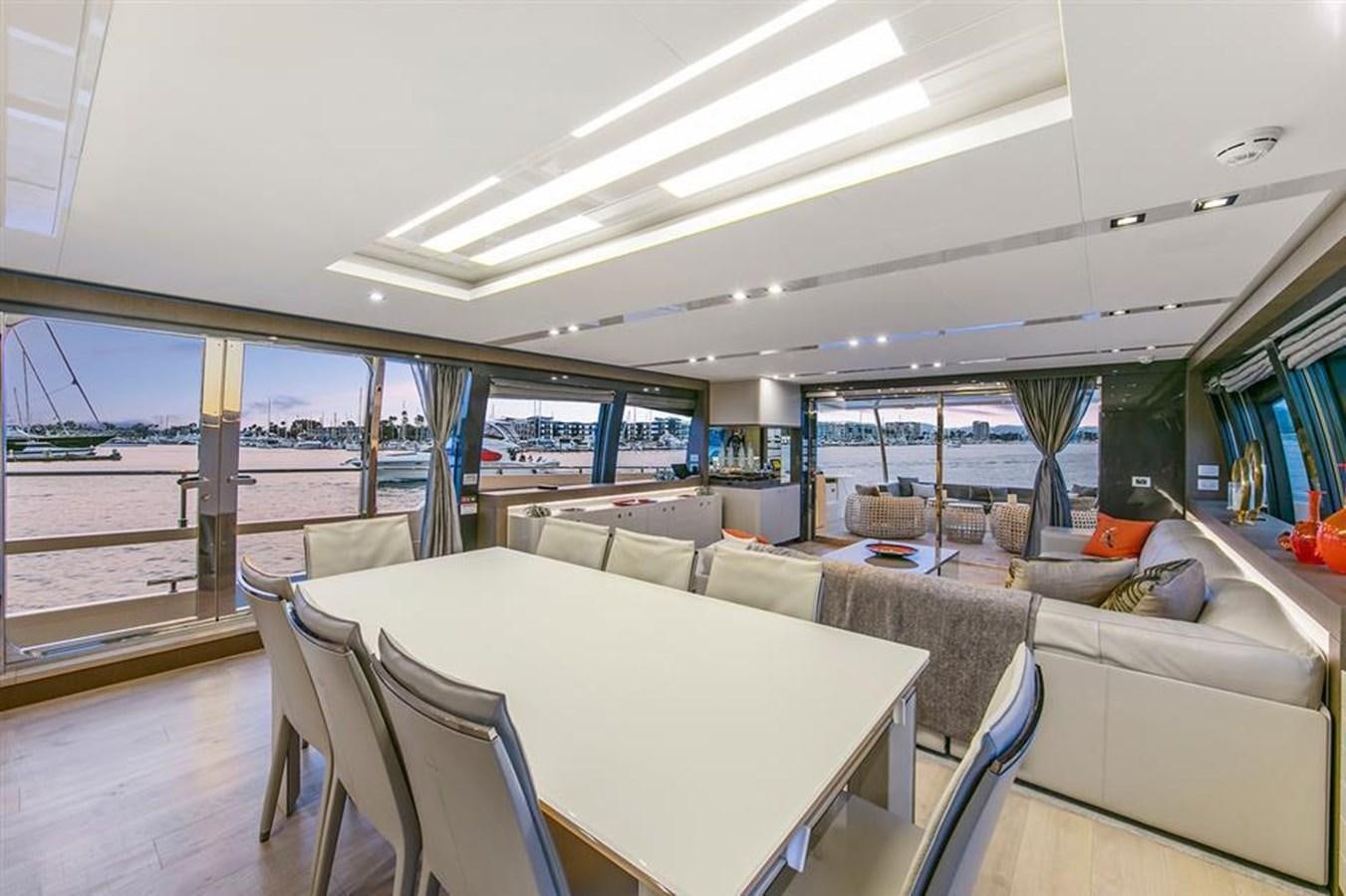 a large room with a table and chairs aboard LONTANO Yacht for Sale