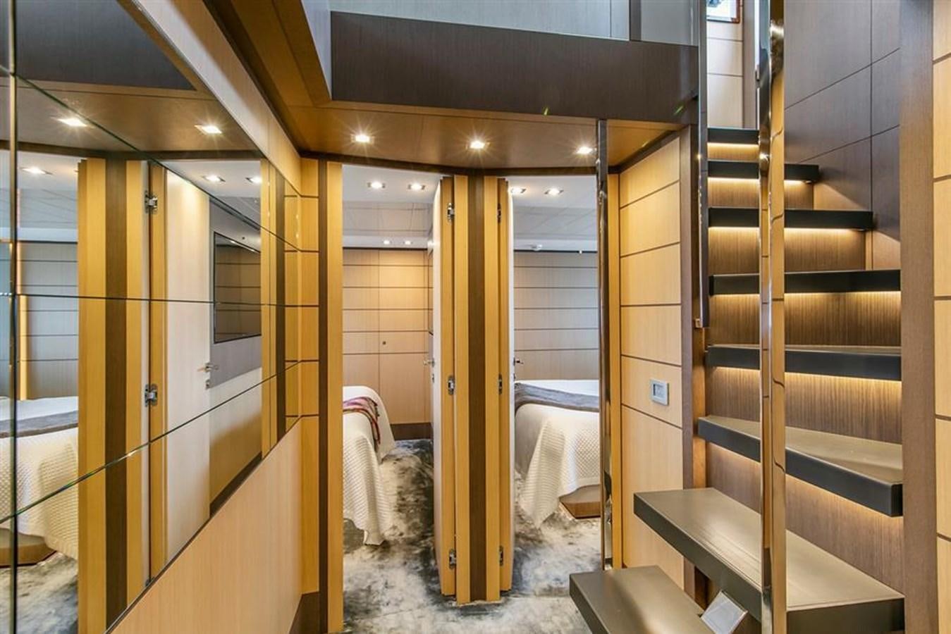a room with a bed and a mirror aboard LONTANO Yacht for Sale