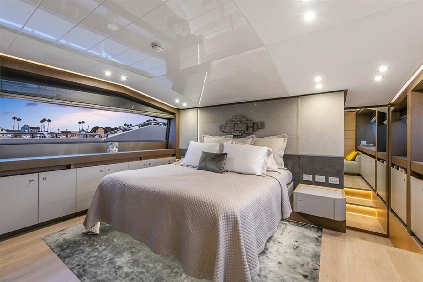 a bedroom with a large window aboard LONTANO Yacht for Sale