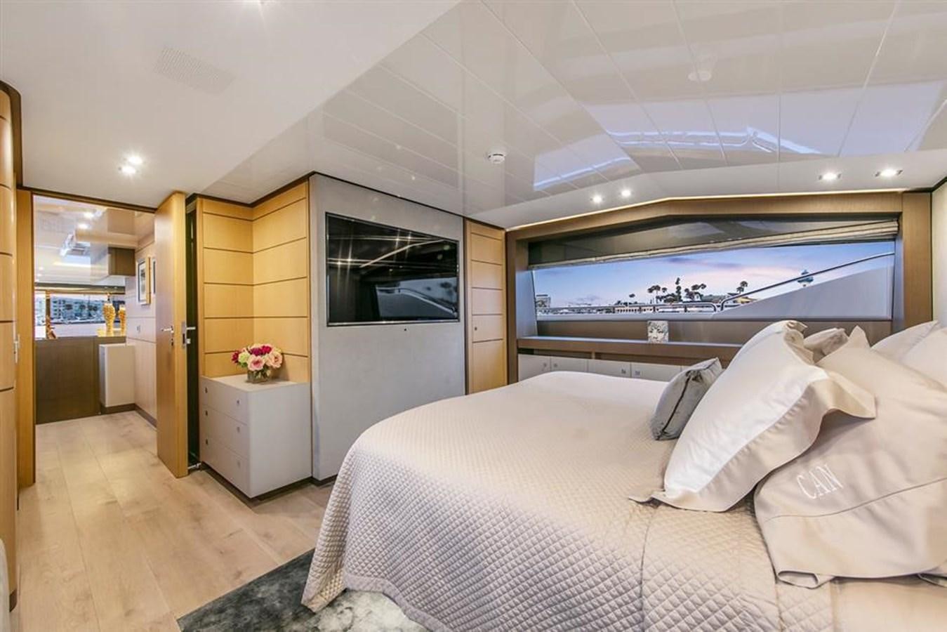 a bedroom with a bed and a tv aboard LONTANO Yacht for Sale