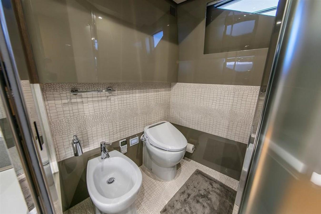 a bathroom with a toilet and sink aboard LONTANO Yacht for Sale