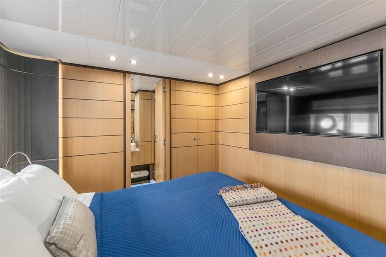 a room with a bed and a tv aboard LONTANO Yacht for Sale