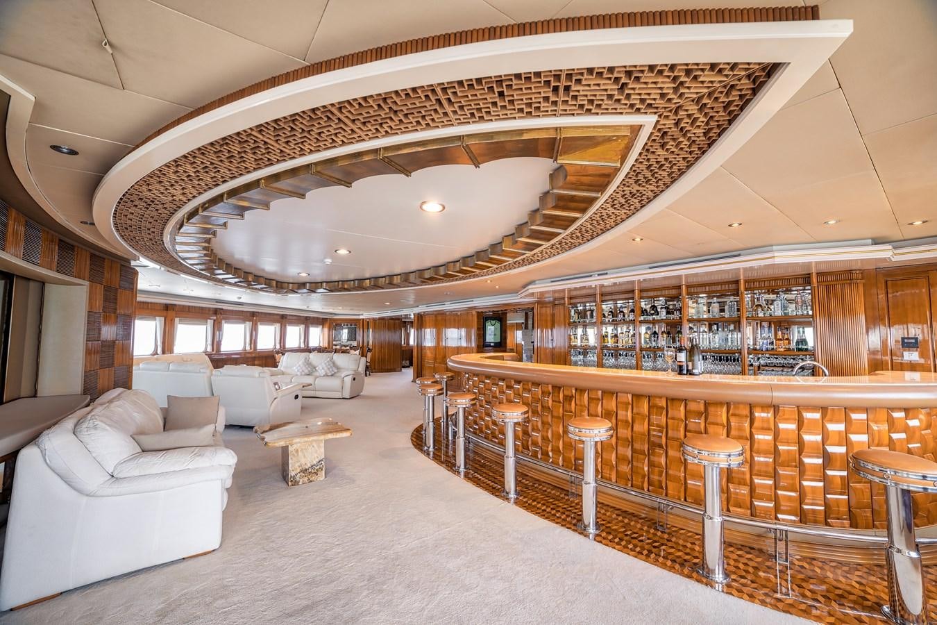 a large room with a large bar and a large table with chairs aboard ASEAN LADY Yacht for Sale