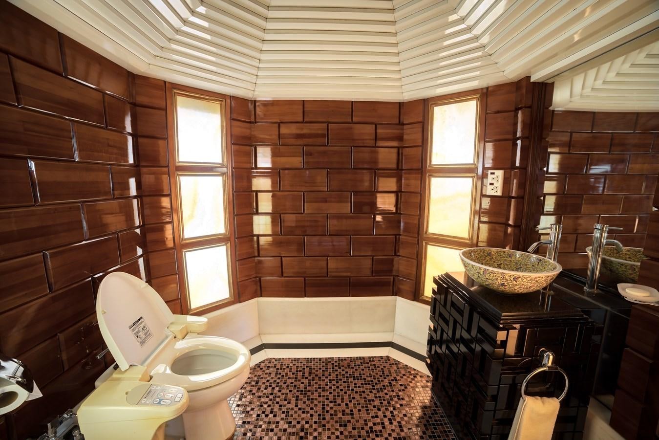 a bathroom with a toilet and a chair aboard ASEAN LADY Yacht for Sale