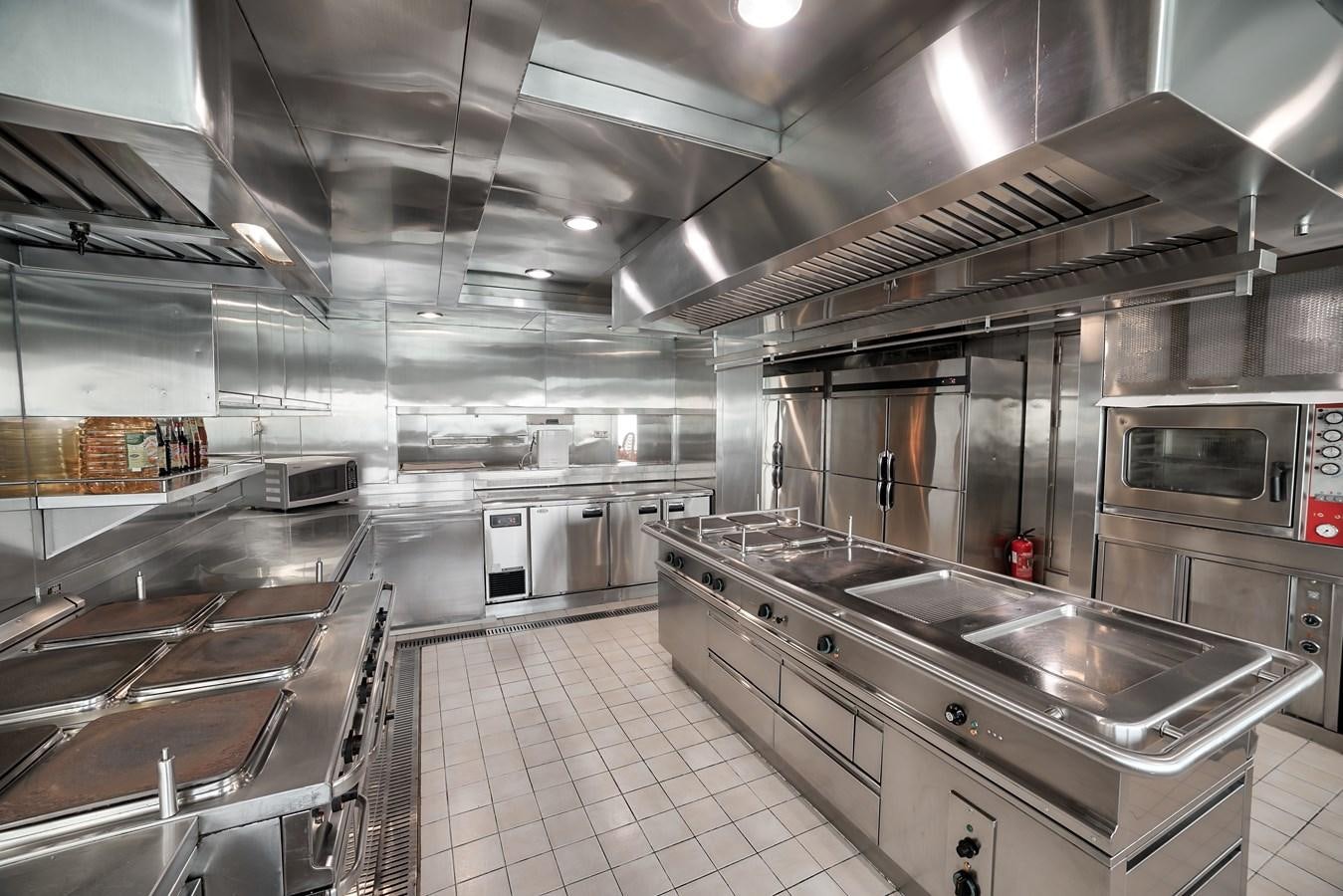 a large kitchen with stainless steel appliances aboard ASEAN LADY Yacht for Sale