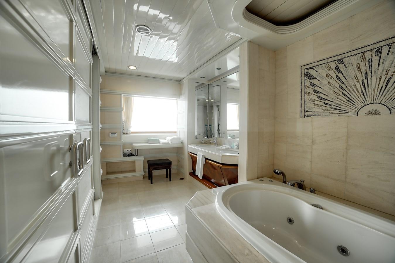 a bathroom with a tub sink and a mirror aboard ASEAN LADY Yacht for Sale