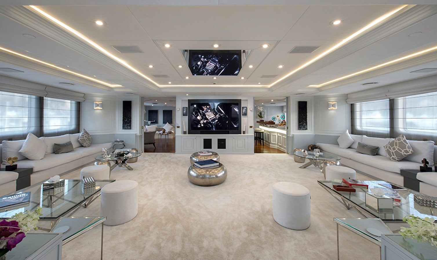 a living room with a large screen aboard CHAKRA Yacht for Charter