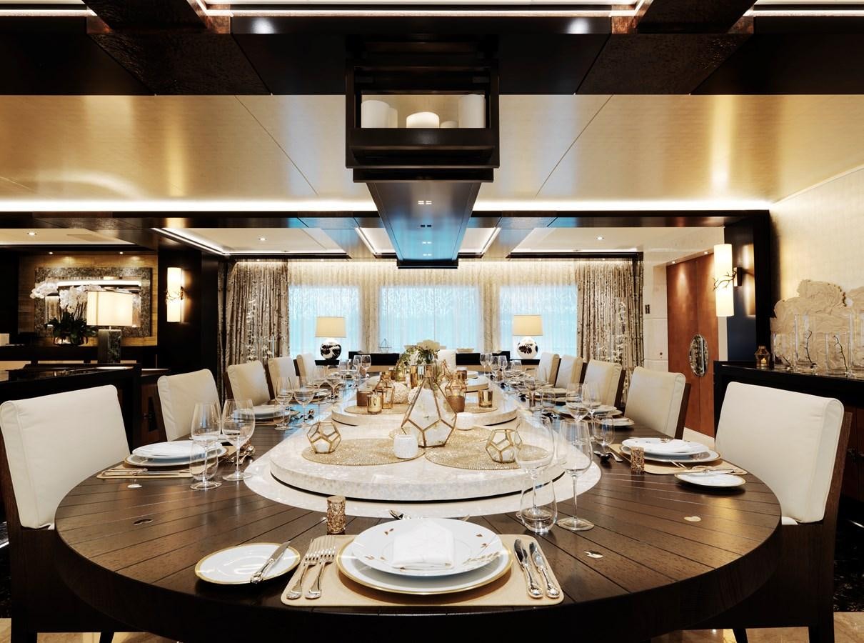 a large dining room table aboard DRAAK Yacht for Sale