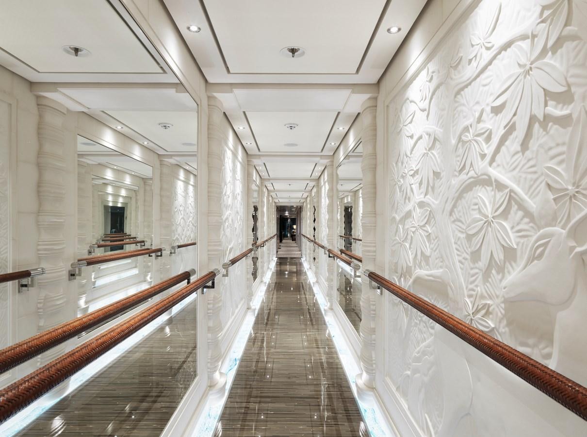 a long hallway with white walls aboard DRAAK Yacht for Sale