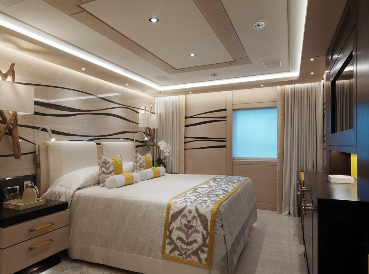 a bedroom with a bed and a window aboard DRAAK Yacht for Sale