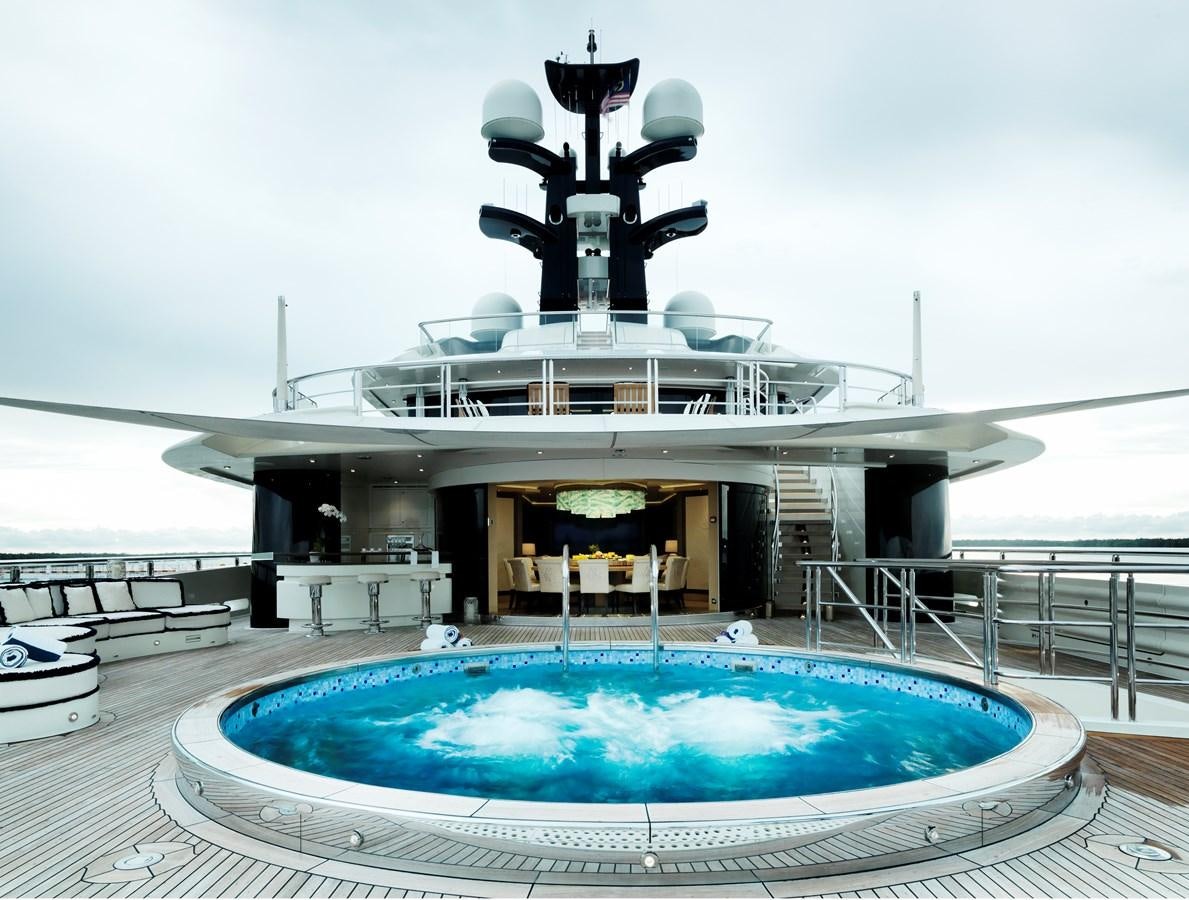 a large white building with a large pool in front of it aboard DRAAK Yacht for Sale