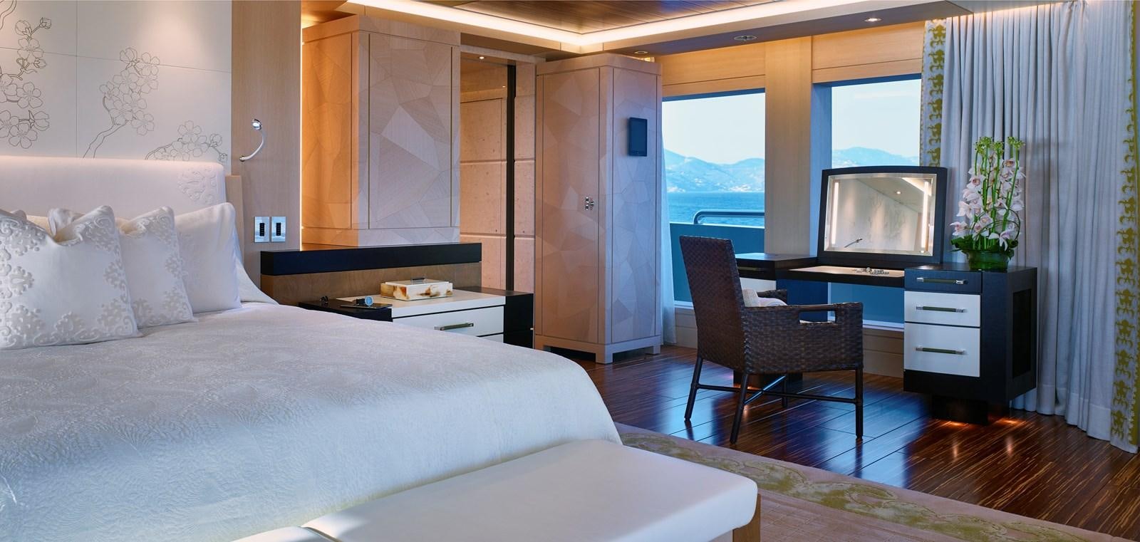 a bedroom with a bed and a tv aboard DRAAK Yacht for Sale