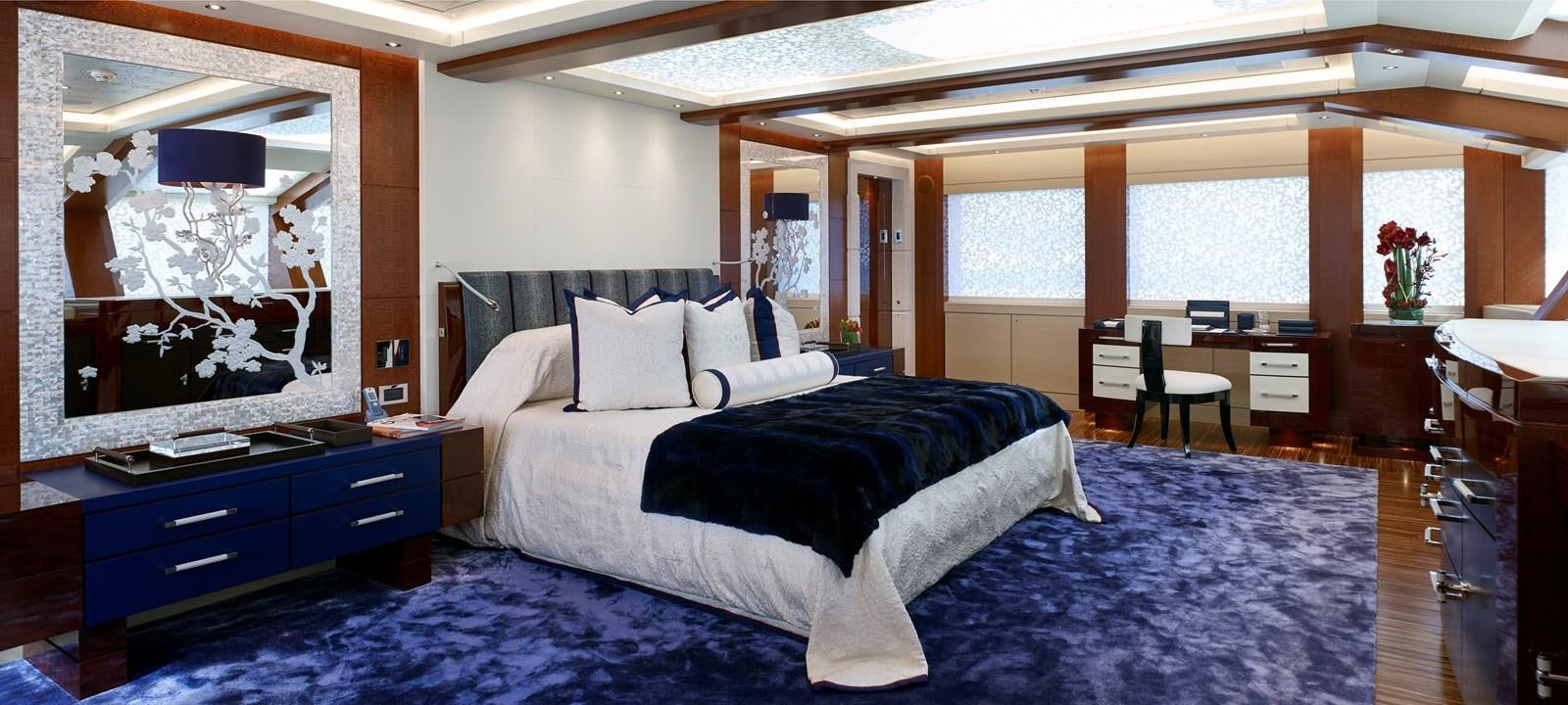 a large bedroom with a large bed aboard DRAAK Yacht for Sale