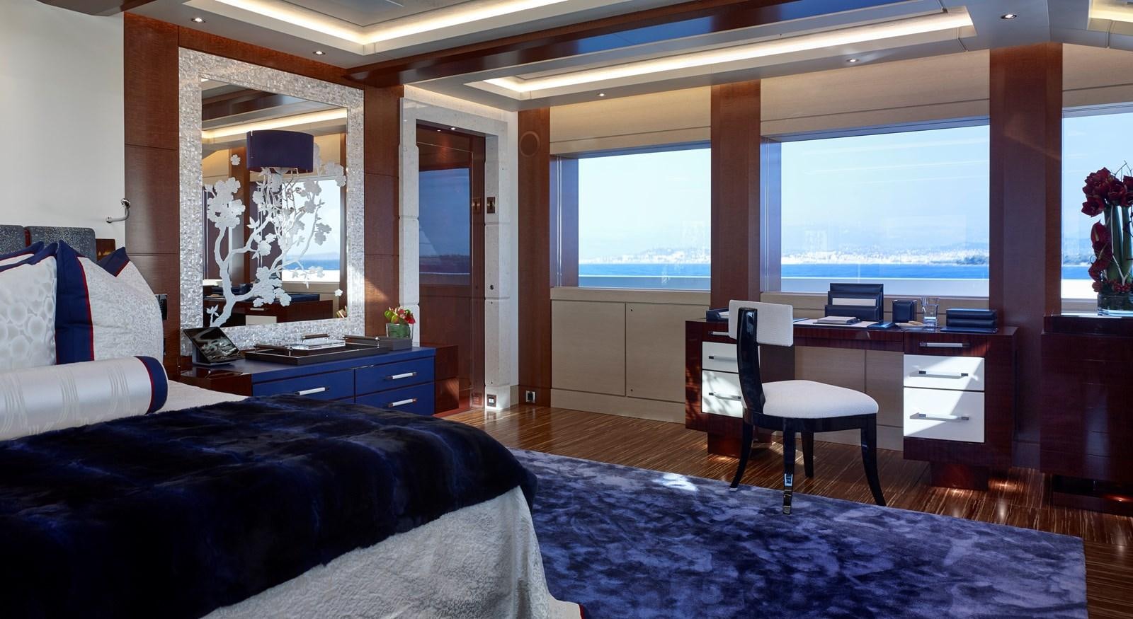 a room with a desk and a bed aboard DRAAK Yacht for Sale