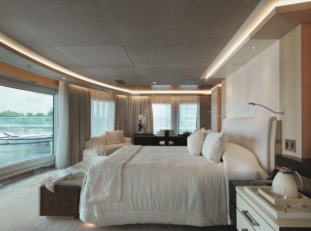 a bedroom with a large bed aboard DRAAK Yacht for Sale