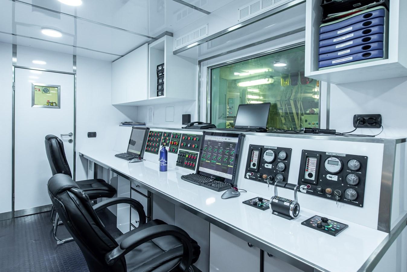 a room with computers and monitors aboard BLEU DE NIMES Yacht for Sale