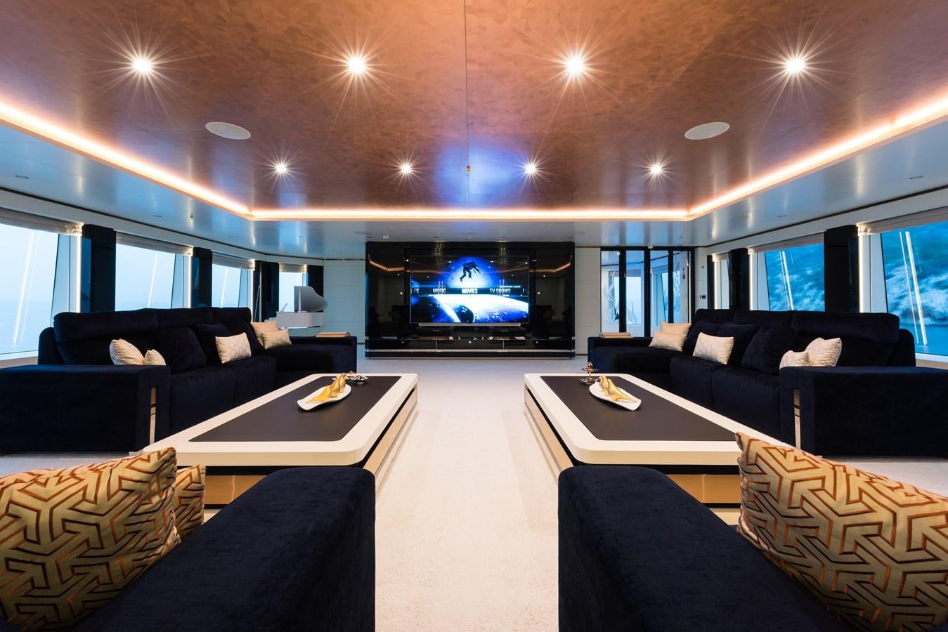 a living room with a large screen aboard ALMAX Yacht for Charter