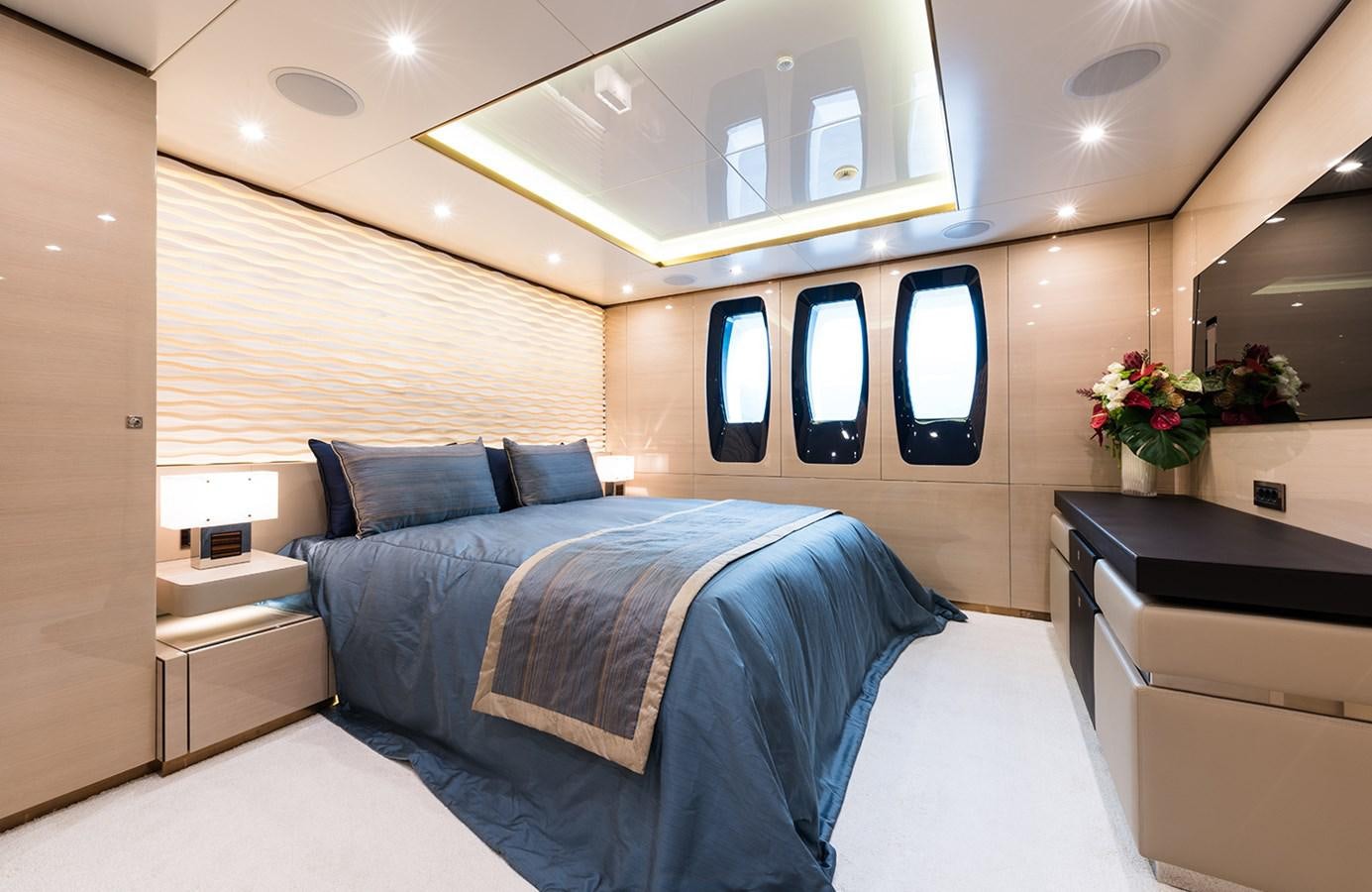 a room with a bed and a desk aboard ALMAX Yacht for Charter