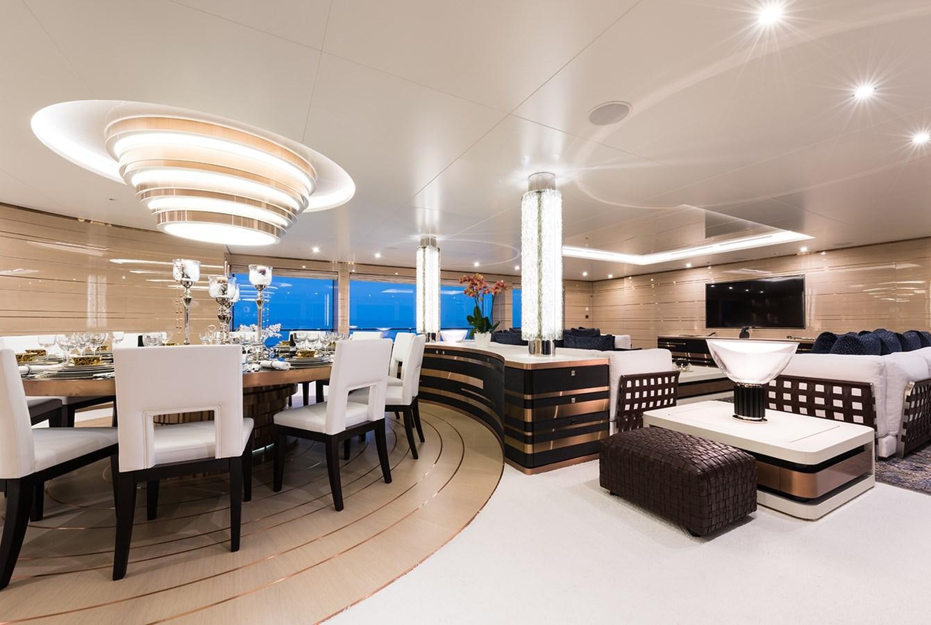 a room with a table chairs and a large window aboard ALMAX Yacht for Charter