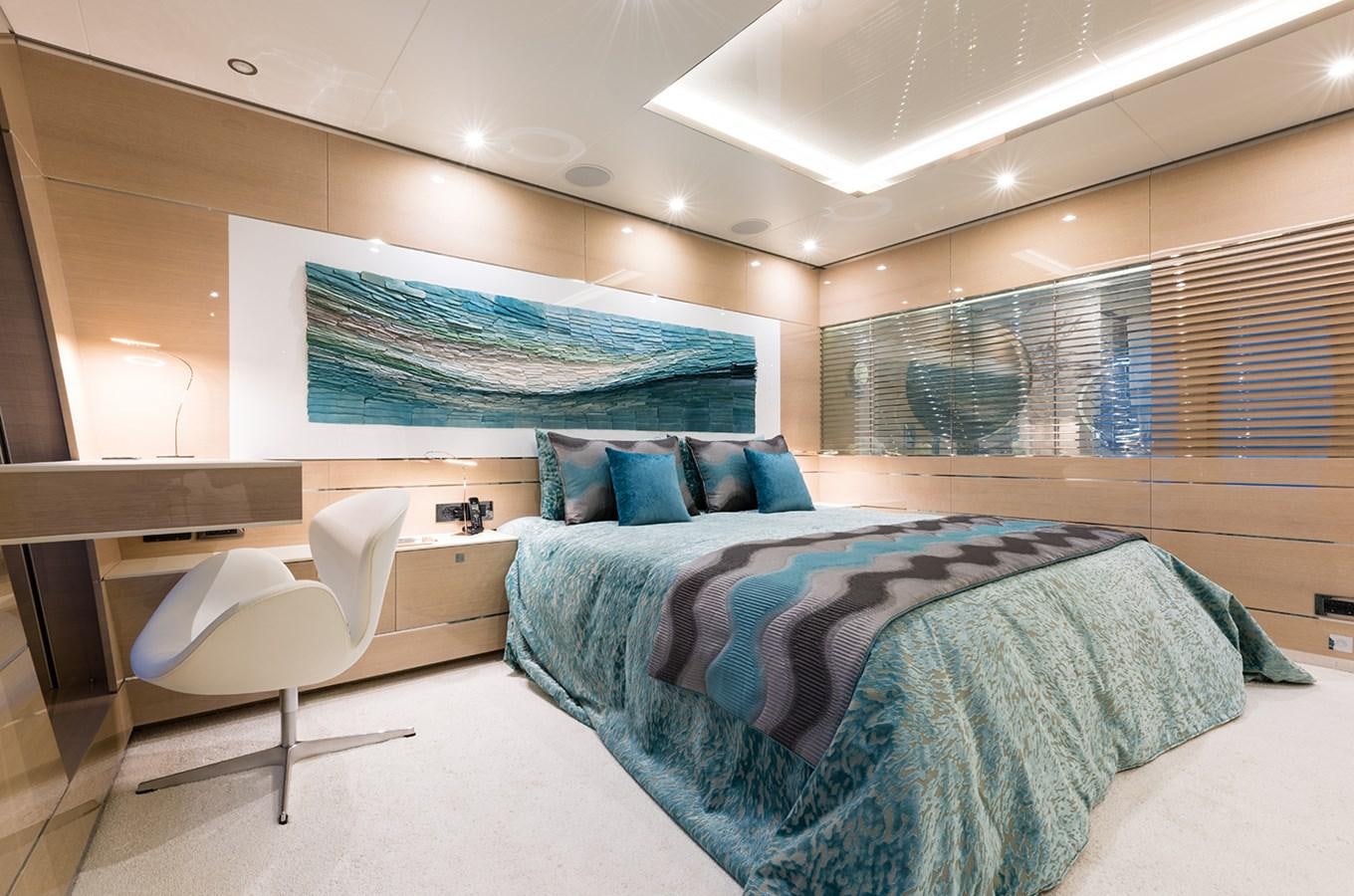 a room with a bed and a chair aboard ALMAX Yacht for Charter