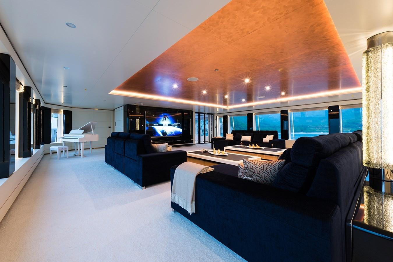 a large living room with a large screen aboard ALMAX Yacht for Charter