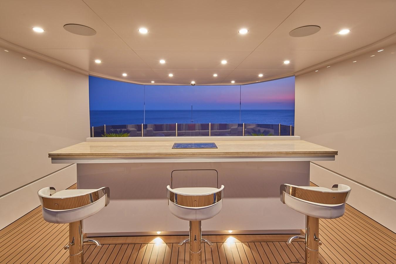 a large room with a table and stools aboard ALMAX Yacht for Charter