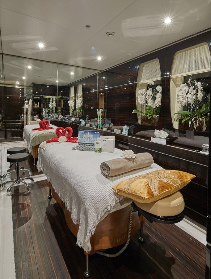 a room with a couple beds aboard ALMAX Yacht for Charter