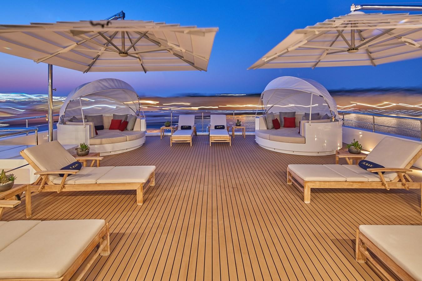 a deck with a view of the water and the deck of a boat aboard ALMAX Yacht for Charter