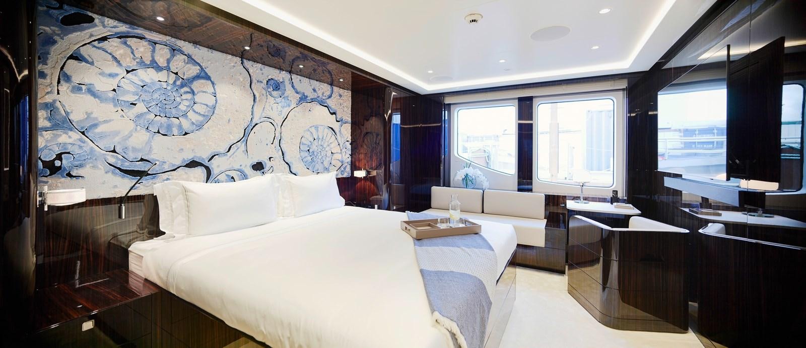 a room with a bed and a desk aboard STARLUST Yacht for Sale