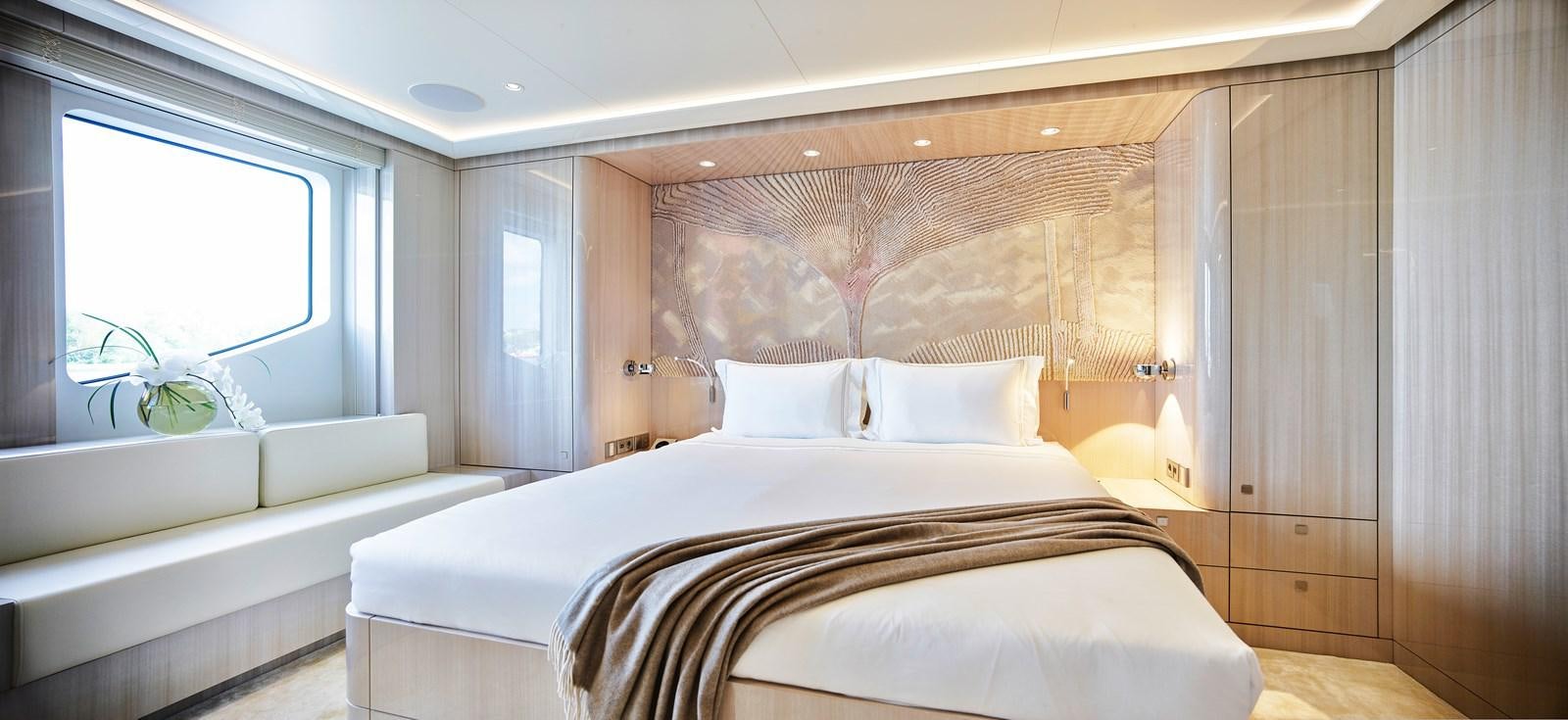 a room with a bed and a window aboard STARLUST Yacht for Sale