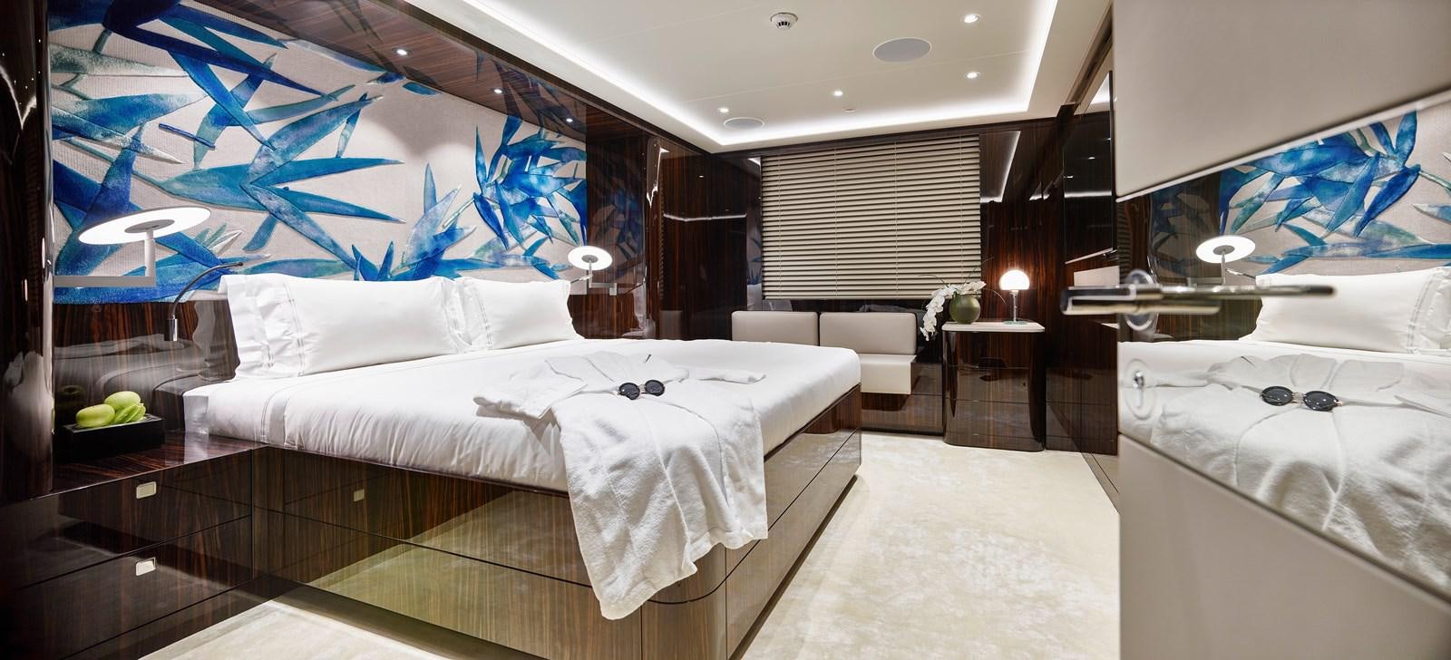 a room with a bed and a desk aboard STARLUST Yacht for Sale